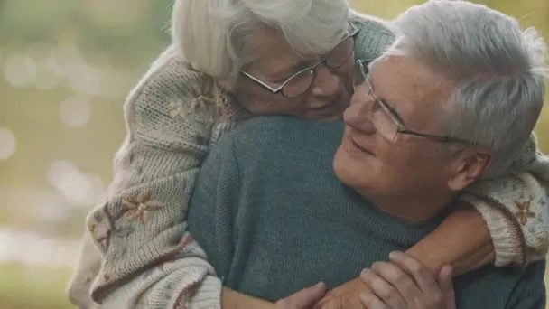 Happy senior couple embracing, supported by long-term care insurance